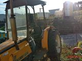 a tractor that is parked in the grass