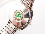 a close up of a watch on a white surface
