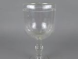 an empty wine glass sitting on top of a table