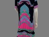 an image of a mannequin wearing a black dress with a pink and blue design