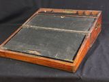 a small wooden box with a glass lid