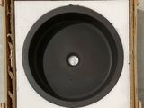 a black sink in a cardboard box on the floor