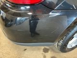 a black car that has a red tail light on it