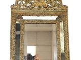 a person taking a picture of a mirror with a cell phone