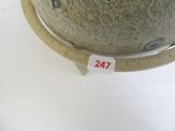 a picture of a globe with a ruler on a table