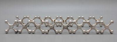 a group of silver figurines that are standing in a row