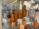 a glass display case filled with different types of teapots