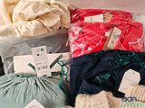 a lot of clothes that are sitting on a table