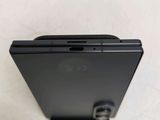 a close up of the back of a cell phone on a white surface