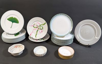 many plates and bowls sitting on a black table