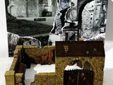 the box contains a model of a castle with a man in armor