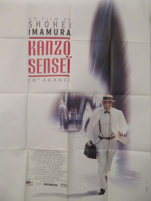 affiche de film représentant un homme en costume blanc et chapeau marchant dans une rue