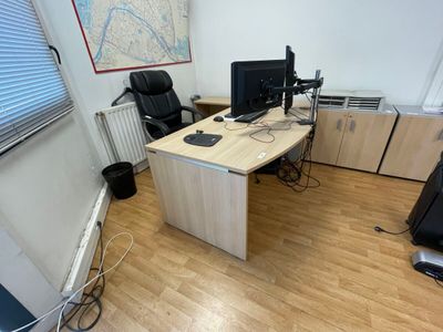 a desk with two monitors and a computer on it