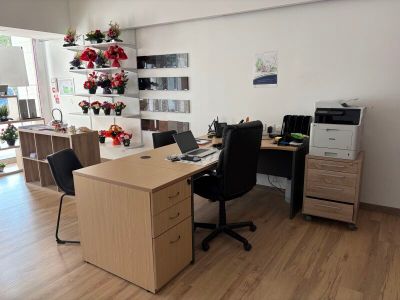 a desk with two chairs and a computer on it
