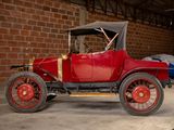 a old red car parked in a garage