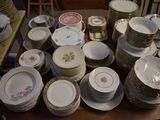 a lot of plates and bowls on the table