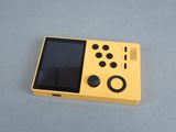 a small yellow game console sitting on a table