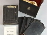 several old books are sitting on a table next to a book case