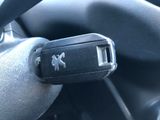 a car key that is attached to the steering wheel of a car