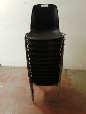 une image représentant une pile de chaises noires dans une pièce