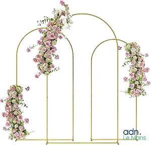 an image of a wedding arch decorated with pink flowers and greenery