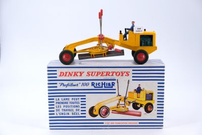 a yellow toy bulldozer sitting on top of a box