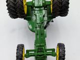 a toy tractor that is sitting on a white surface