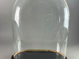 an image of a glass clochet with a black base