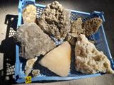 a blue basket filled with different types of rocks