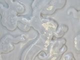 a close up of a white vase with a dragon on it