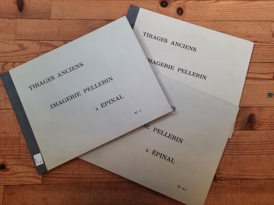 two books sitting on top of a wooden table next to each other