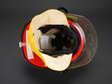 a fireman ' s helmet with a yellow visor on it