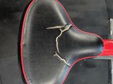 a red and black seat on a black floor