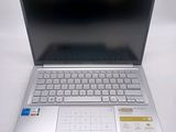 a silver laptop with a keyboard on a white surface
