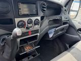 the interior of a car with a steering control and dashboard controls