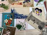 many cards and postcards on a table with a white table cloth