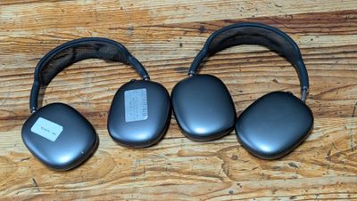 three headphones that are sitting on a wooden table