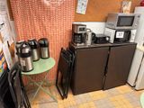 a small kitchen with a lot of appliances and a table