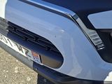 a close up of the front bumper of a white truck