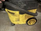 someone is using a vacuum cleaner to clean the floor of a garage
