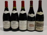 six bottles of red wine are lined up on a table