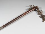 an old wooden stick with a metal handle on a white surface