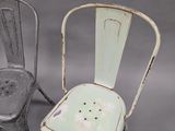 two chairs sitting next to each other on a gray surface