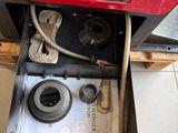 a red suitcase that has a box with a camera inside of it