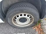 a tire that is sitting on the ground next to a car
