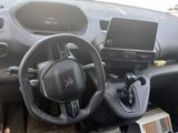 a car dashboard with a steering wheel and a phone in it