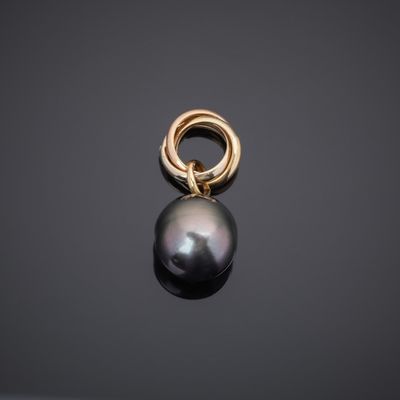 a black pearl and gold ring pendant on a black background