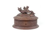 an image of a bronze box with a dog and cat on it