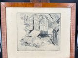 an old picture of a dog laying on the ground in front of a wooden easel