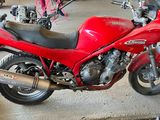 a red motorcycle that is parked in a garage